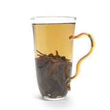 Bright amber-gold tea liquor of 2015 Sweet Plum-Scented Aged White Tea showing rich clarity.