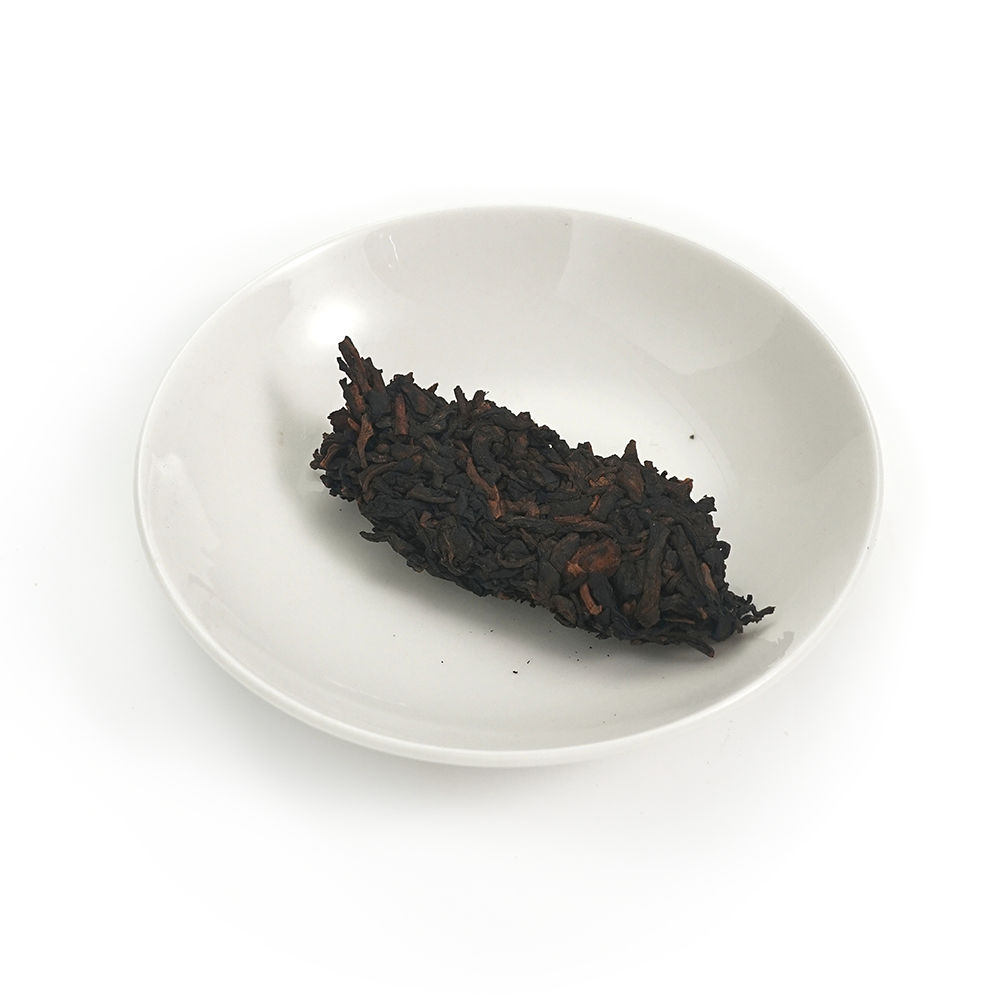 Aged tea leaves showing deep brown-black fermentation tone