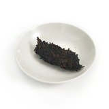 Aged tea leaves showing deep brown-black fermentation tone