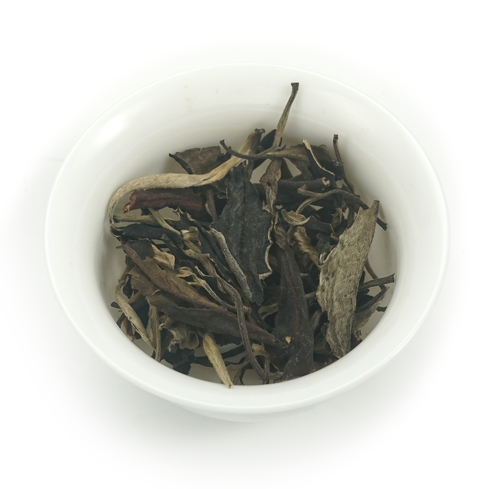 Detailed view of the distinctive black and white contrast in 2015 Moonlight White loose leaf tea.