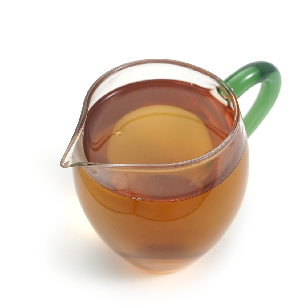 Honey-scented tea liquor of Yunnan Da Xue Shan Black Tea in a glass gongfu cup.