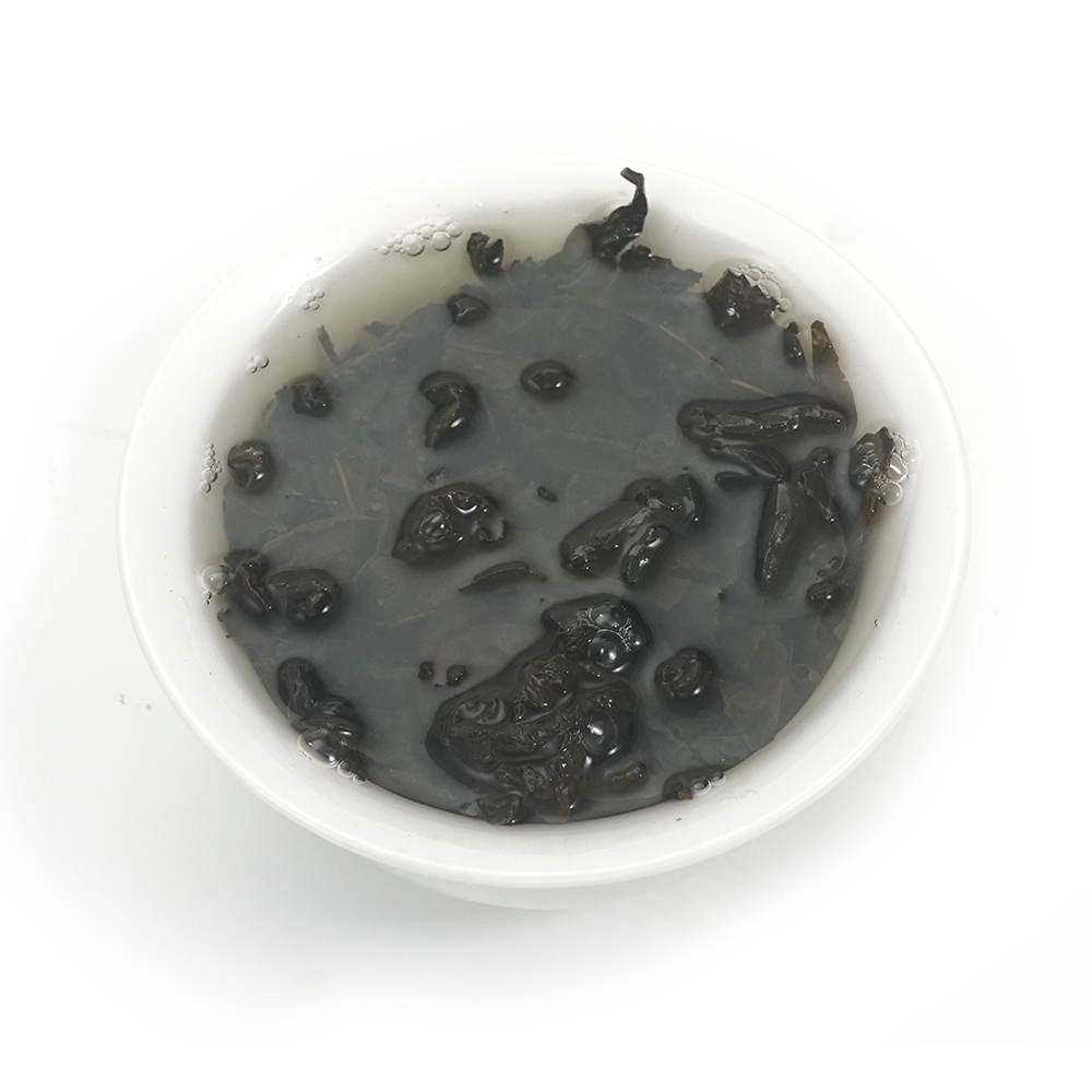 Infused leaves of Charcoal Roasted Tie Guan Yin showing roasted edges