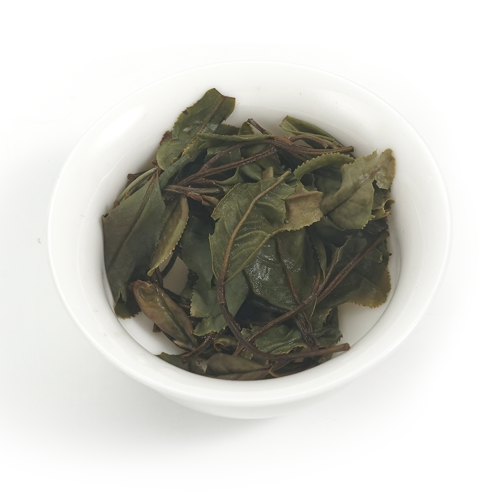 Detailed view of 2025 Herbal-Woody Shou Mei white tea leaves, showcasing the integrity of sun-dried foliage.