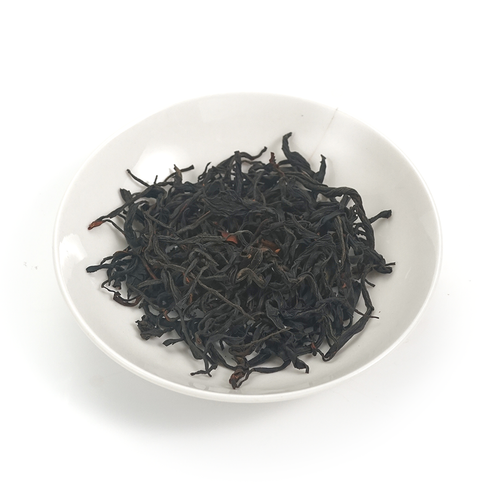 Tightly curled wiry strips of Yunnan Black Beauty Dianhong tea leaves with a honey-fruity aroma.