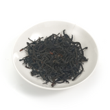 Tightly curled wiry strips of Yunnan Black Beauty Dianhong tea leaves with a honey-fruity aroma.